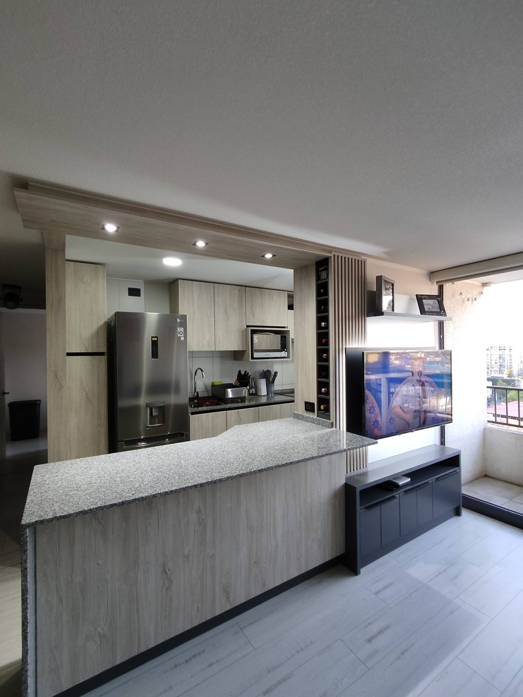 Cocina Vicuña: cocina integrada al living con isla, bar de copas y rack de TV